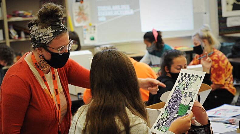 A Beavercreek High School teacher works with art students on Oct. 8, 2020.