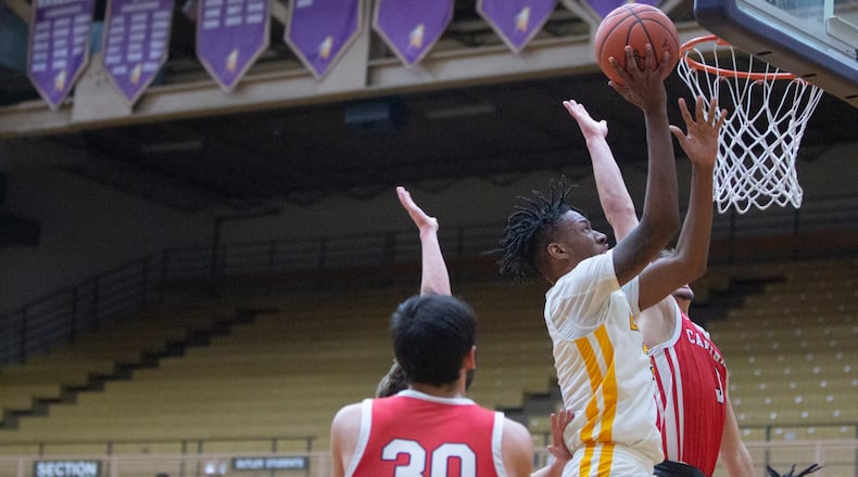 Meadowdale's Lee Benson III scores off a spin move in the lane against Triad during Thursday night's Division III tournament game at Vandalia Butler. Jeff Gilbert/CONTRIBUTED