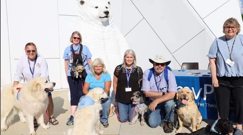Pam Killingsworth (left) with Tucker, joins other members of the Miami Valley Pet Therapy Association team at the Community Night Out in Trotwood. CONTRIBUTED