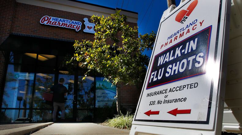 Dr. Kindy Ghussin, the owner of Heartland Pharmacy in Kettering, is ready to administer flu shots. LISA POWELL / STAFF
