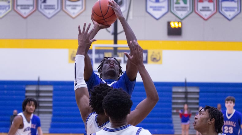 Carroll's 6-foot-10 Maro Egodotaye scores off of an offensive rebound during Tuesday night's Division II sectional game at Springfield High School. Jeff Gilbert/CONTRIBUTED