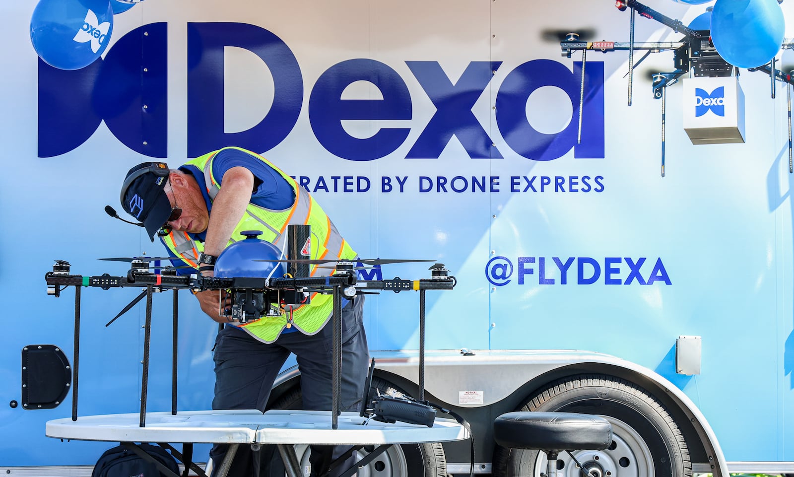 Ralph Newcomb works on a drone operated by DEXA during a test flight on Wednesday, July 23 at TJ Chumps in Kettering. Newcomb is a pilot and manager of hazadorous materials for the company. BRYANT BILLING / STAFF