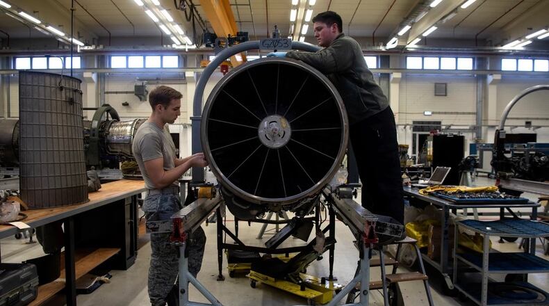 In this 2020 photo, Air Force Staff Sgt. John Barickman, 52nd Maintenance Squadron aerospace propulsion craftsman, left, and Airman 1st Class Austin Wise, 52nd MXS aerospace propulsion journeyman, install an F110-GE-129 jet engine upper-fan stator case at Spangdahlem Air Base, Germany. (U.S. Air Force photo by Airman 1st Class Valerie Seelye)