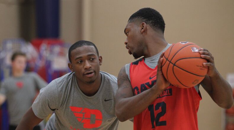 Dayton’s Kendall Pollard, left, guards Trey Landers as the team shoots around before the first practice of the season on Monday, Oct. 10, 2016, at the Cronin Center. David Jablonski/Staff
