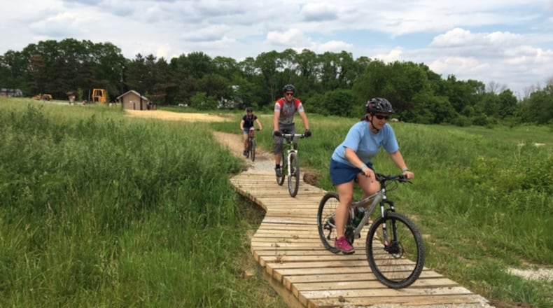Three MetroParks employees try out the new Hilltop Flow trail at Huffman MetroPark’s mountain biking facility.