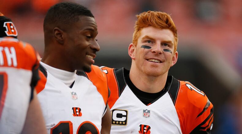 CLEVELAND, OH — DECEMBER 6: Andy Dalton #14 and A.J. Green #18 of the Cincinnati Bengals smile on the sideline late in the fourth quarter while playing the Cleveland Browns at FirstEnergy Stadium on December 6, 2015 in Cleveland, Ohio. Bengals won the game 37-3. (Photo by Gregory Shamus/Getty Images)