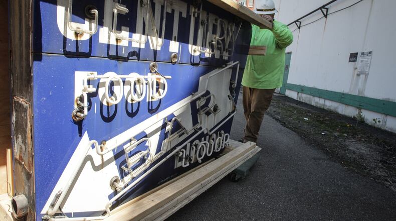Work crew moved the Century Bar sign out of storage to load it on William Jergens truck. JIM NOELKER/STAFF