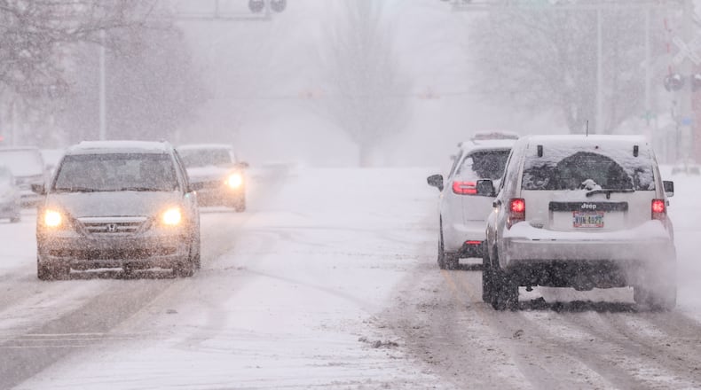 Vehicles drive on East Main Street in Troy on Saturday, Dec. 13. Up to six inches of snow was expected in parts of the area. BRYANT BILLING/STAFF