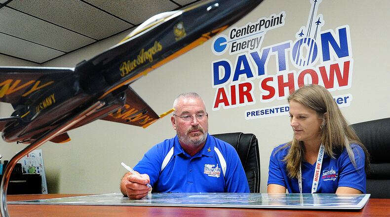 Kevin Franklin, the executive director of the CenterPoint Energy Dayton Air Show, and Wright Brothers Aero manager, Katie Mitchell, look over plans Tuesday, May 28, 2024 for the upcoming CenterPoint Energy Dayton Air Show. MARSHALL GORBY\STAFF