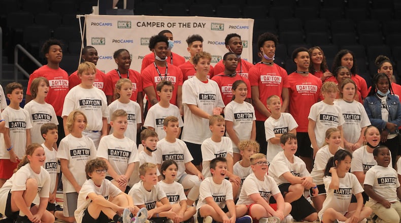 Dayton men's and women's basketball players pose for a photo with fans who participated in a basketball camp at the Henny Penny Red Blue Dayton Basketball Fan Fest on Saturday, Oct. 16, 2021, at UD Arena. David Jablonski/Staff