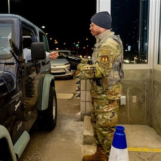 An airmen with the 88th Security Forces Squadron checks an identification card at Gate 15A at Wright-Patterson Air Force Base on Feb. 25, 2025. (Air Force photo by Jack Gardner)