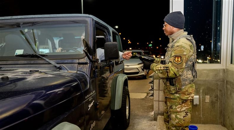 An Airmen with the 88th Security Forces Squadron checks an identification card at Gate 15A at Wright-Patterson Air Force Base on Feb. 25, 2025. (U.S. Air Force photo by Jack Gardner)