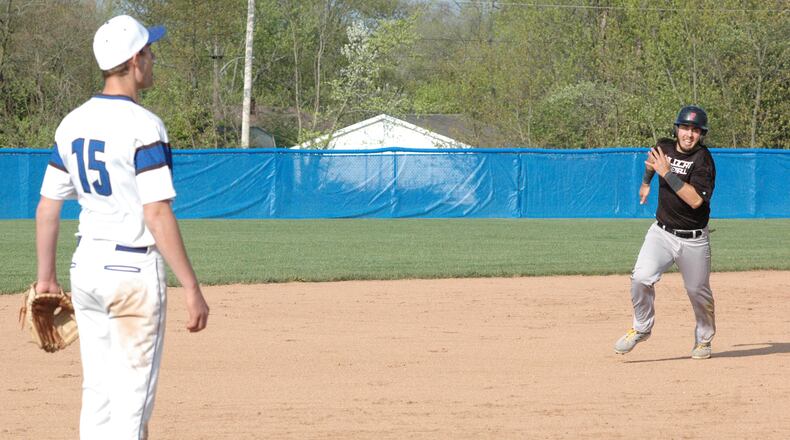 Franklin’s Aaron Blake rounds second base and heads toward Brookville third baseman Carter Pickens (15) during Tuesday’s Southwestern Buckeye League Southwestern Division baseball game at Brookville. The host Blue Devils won 5-4. RICK CASSANO/STAFF