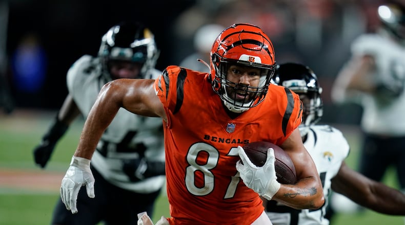 Cincinnati Bengals' C.J. Uzomah (87) goes in for a touchdown during the second half of an NFL football game against the Jacksonville Jaguars, Thursday, Sept. 30, 2021, in Cincinnati. (AP Photo/Michael Conroy)