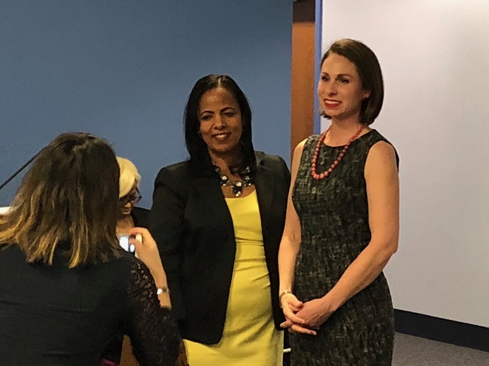 Dayton school board member Jocelyn Rhynard (right) has her picture taken by district communications staff after she was sworn in as school board vice president by DPS treasurer Hiwot Abraha (left) on Tuesday, Jan. 8, 2018. JEREMY P. KELLEY / STAFF
