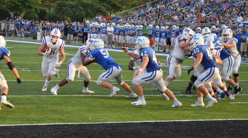 Middletown’s Gene Underhill (21) carries the ball as he’s pursued by Springboro defenders Calvin Walters (34), Jake Kowalski (54), Cameron Snurr (42) and Lincoln Troxell (40) on Friday night at CareFlight Field in Springboro. CONTRIBUTED PHOTO BY ERIC FRANTZ