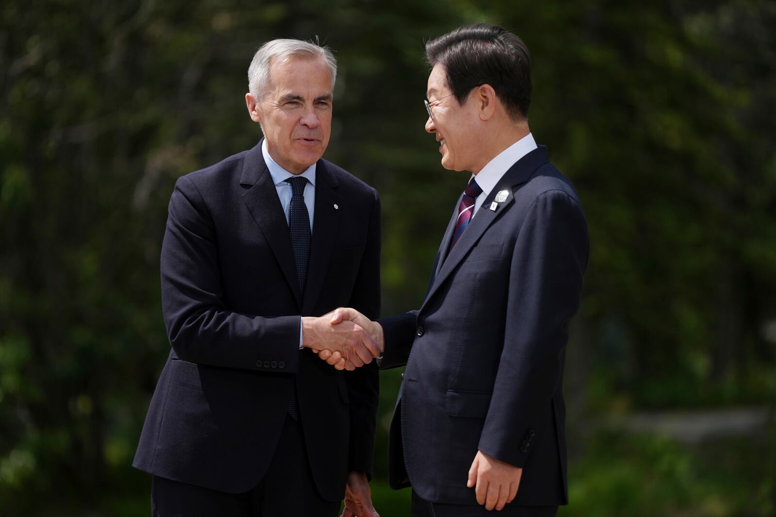 Canadian Prime Minister Mark Carney welcomes South Korean President Lee Jae-myung to the G7 Summit in Kananaskis, Alberta, Canada on Tuesday, June 17, 2025. (Darryl Dyck/The Canadian Press via AP) /The Canadian Press via AP)