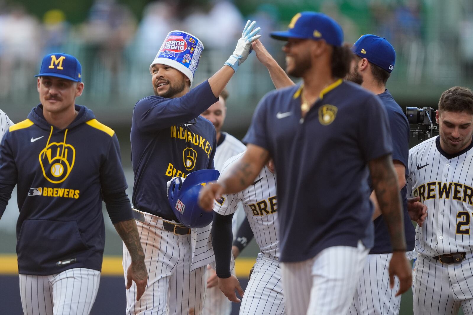 Milwaukee Brewers' Blake Perkins, second from left, is congratulated by teammates after hitting a walkoff RBI single during the ninth inning of a baseball game against the Miami Marlins, Sunday, July 27, 2025, in Milwaukee. (AP Photo/Aaron Gash)