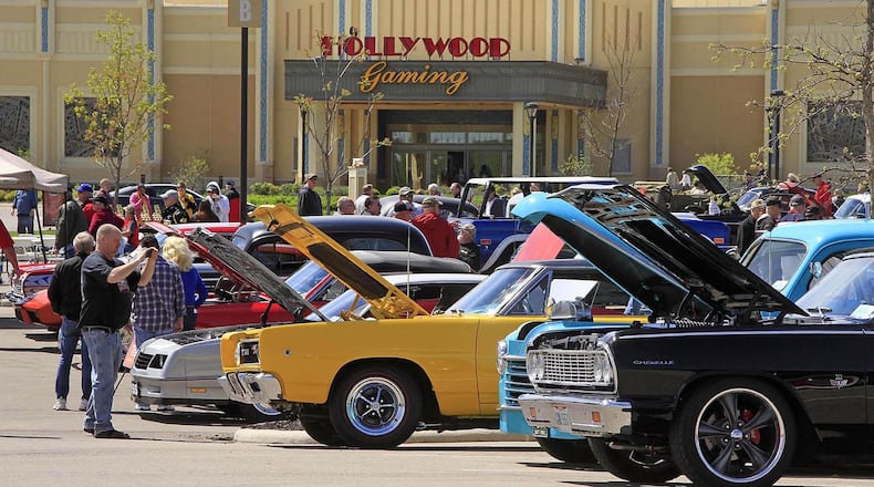 Spectators take pictures of the cars at the cruise-in at Hollywood Gaming at Dayton Raceway in a previous year. This year’s show will be April 28. © Photo by Skip Peterson
