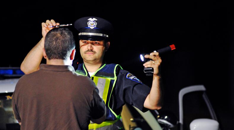 Monroe police officer Doug Leist gives a field sobriety test to a man stopped during an OVI checkpoint Early Saturday morning, June 11, 2011 along OH-4 in Monroe, Ohio. Monroe police, along with Middletown police and the Ohio State Highway Patrol, participated in the checkpoint. Staff photo by Nick Graham
