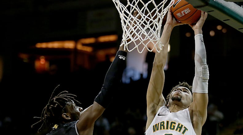 Wright State University guard Tanner Holden adds two against IUPUI forward Zo Tyson during their Horizon League game at the Nutter Center in Fairborn Sunday, Feb. 16, 2020. Wright State won 106-66. Contributed photo by E.L. Hubbard