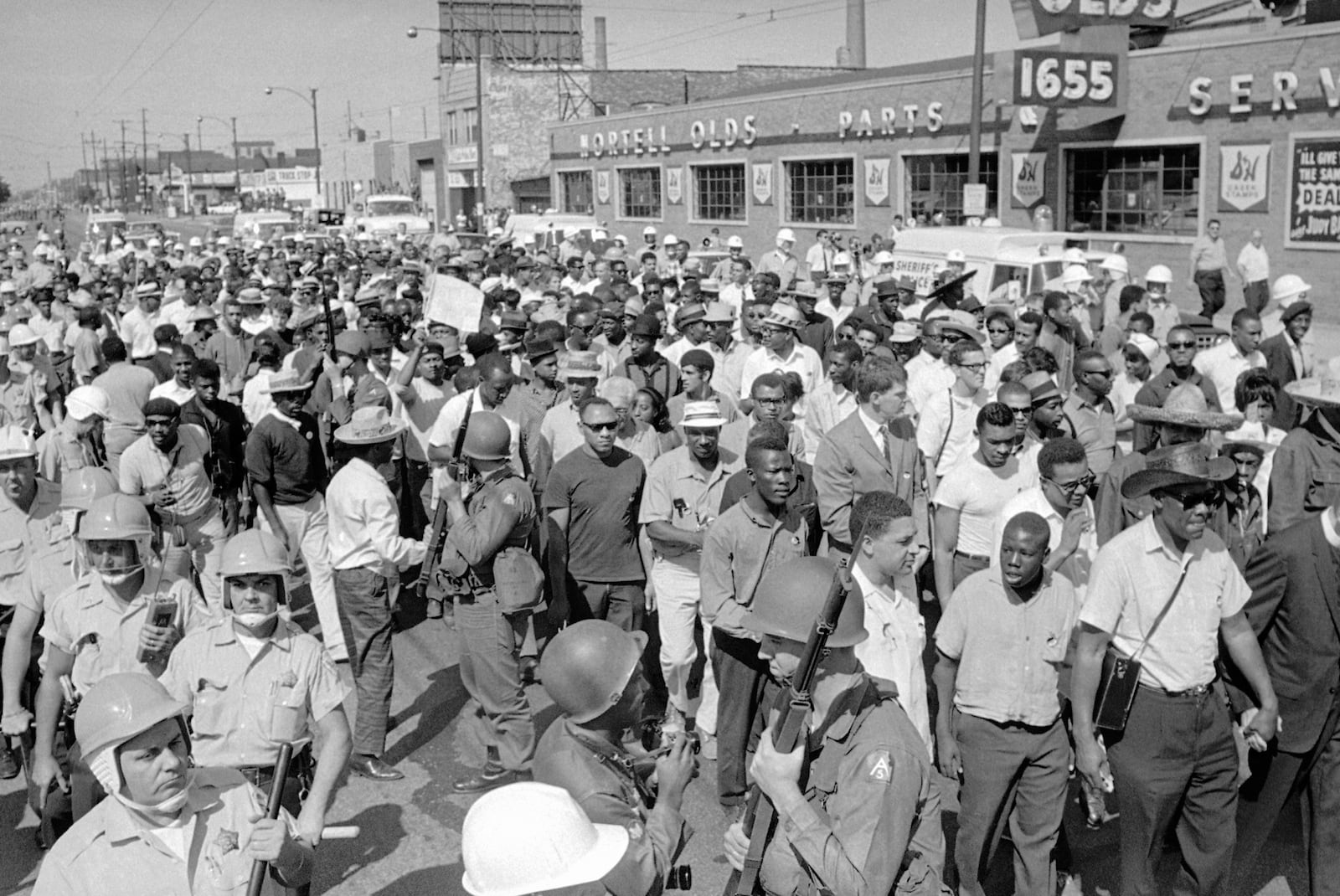 FILE - A civil rights march is conducted on Sept. 4, 1966 in close quarters on Cicero Ave., a main street of this suburb of Chicago. At left, the police; then National Guardsmen with bayonets on rifles, then marchers, then crowd. (AP Photo, file)