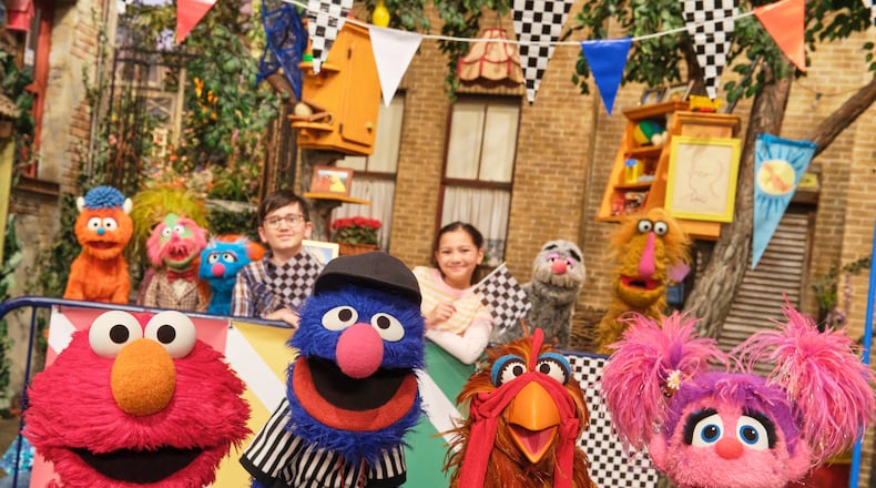 This image released by Sesame Workshop shows muppet characters Elmo, left, Grover, second left, and Abby, right, from the "Sesame Street" episode "Elmo Runs the Race." (Zach Hyman/Sesame Workshop via AP)