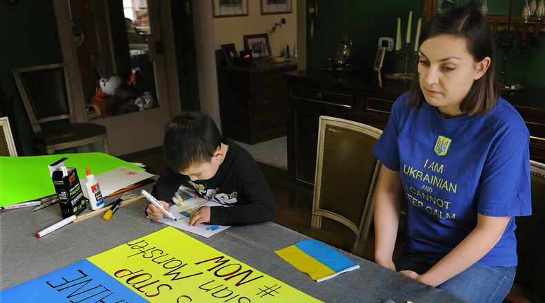 Anastasia Nagle with her son Christoper, age 6, prepare posters for a upcoming rally to show support for the Ukraine. MARSHALL GORBY\STAFF
