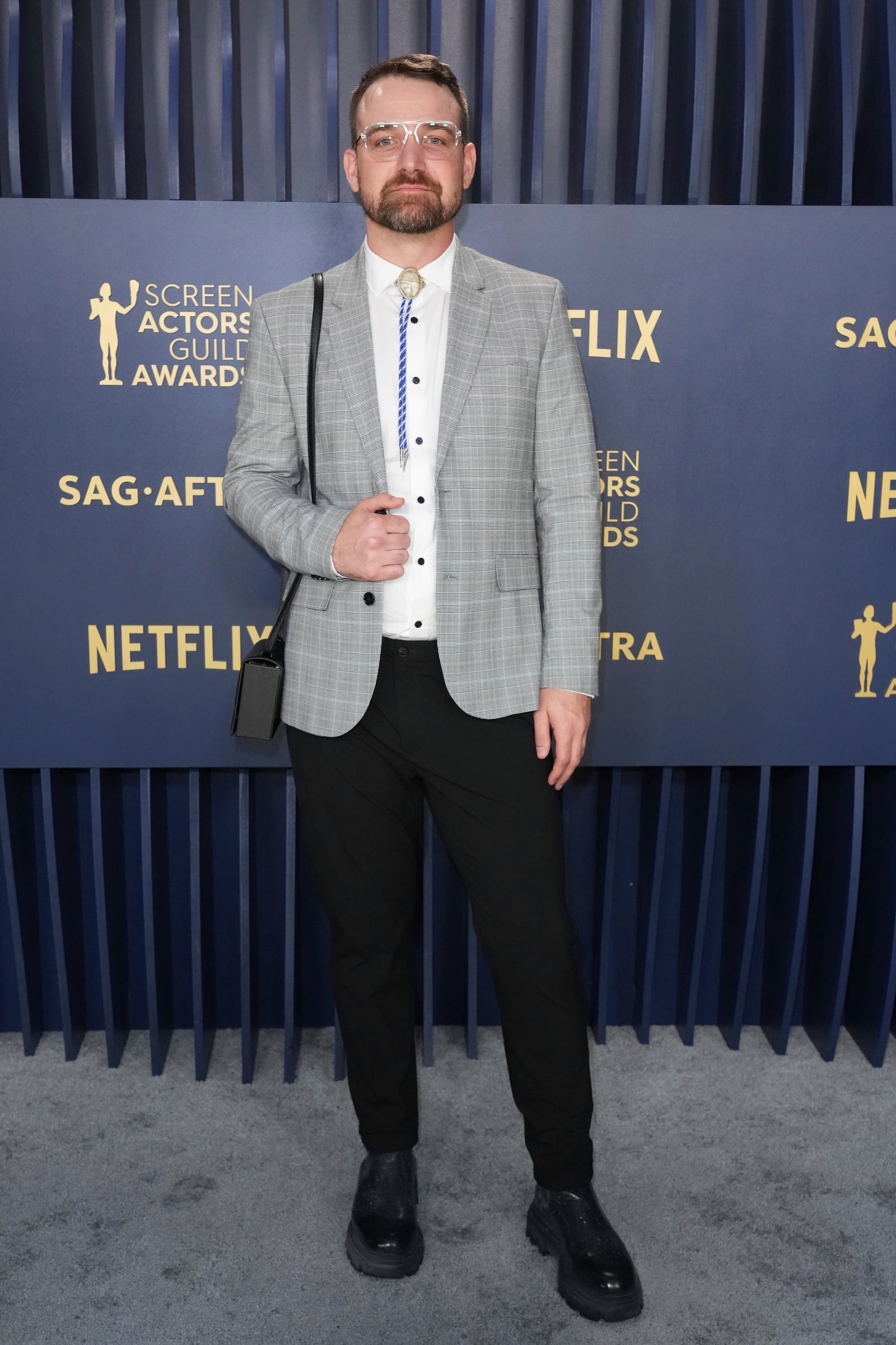 Micah Stock arrives at the 30th annual Screen Actors Guild Awards on Saturday, Feb. 24, 2024, at the Shrine Auditorium in Los Angeles. (Photo by Jordan Strauss/Invision/AP)