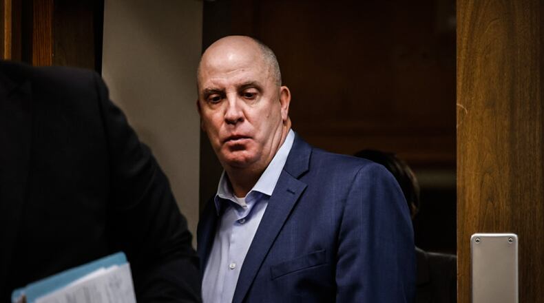 Former Montgomery County prosecutor John Amos enters Judge Daniel Hogan's courtroom Friday morning at the Montgomery County Common Pleas Court. Amos was sentenced for sexual imposition and assault. JIM NOELKER/STAFF