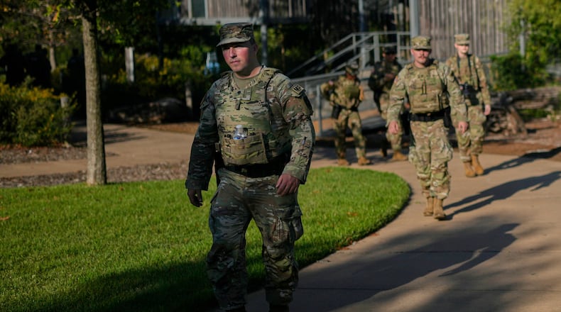 Members of the National Guard patrol a park along the Mississippi River, Saturday, Oct. 11, 2025, in Memphis, Tenn. (AP Photo/George Walker IV)