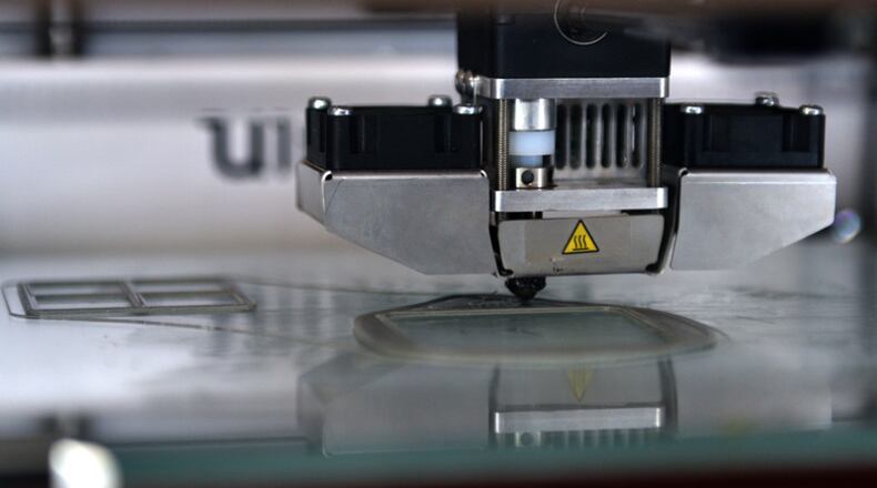 A 3D printer creates a prototype N95 face mask at the Louis F Garland Department of Defense Fire Academy on Goodfellow Air Force Base, Texas, March 31, 2020. This is the medical regulation/grade personal protective equipment that is used to protect the wearer from airborne particles and from liquid contaminating the face. (U.S. Air Force photo by Airman 1st Class Robyn Hunsinger)