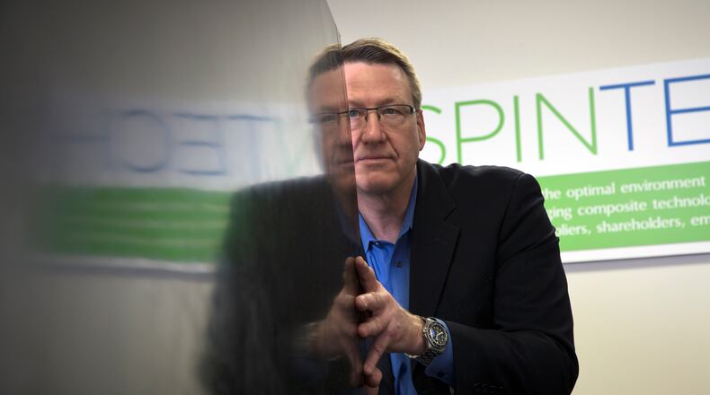 SpinTech president Craig Jennings is reflected in a large composite panel his company produced for a leading rocket company. TY GREENLEES / STAFF