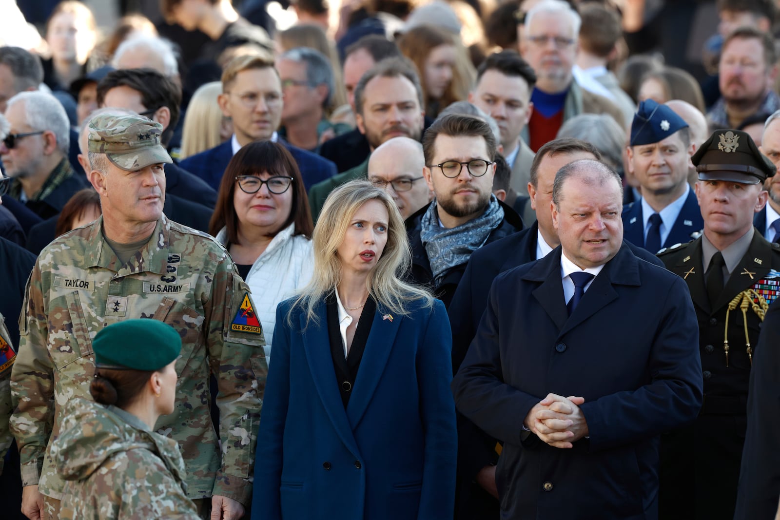 U.S. Ambassador to Lithuania Kara C. McDonald, center left, and Speaker of Lithuanian Parliament Saulius Skvernelis, center right, attend a solemn farewell ceremony at Cathedral Square in Vilnius, Lithuania, Thursday, April 3, 2025 for the US soldiers who died during training exercise. (AP Photo/Mindaugas Kulbis)