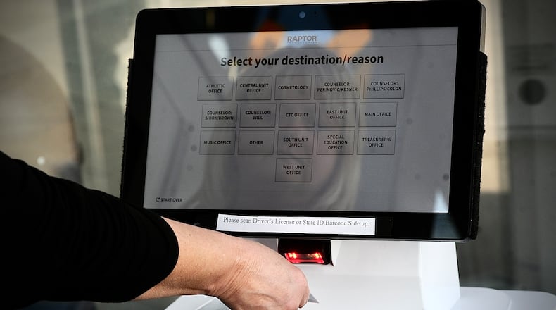 The Raptor safety system already in place at Kettering's Fairmont High School requires visitors to scan their ID and log where in the building they're going. MARSHALL GORBY / STAFF