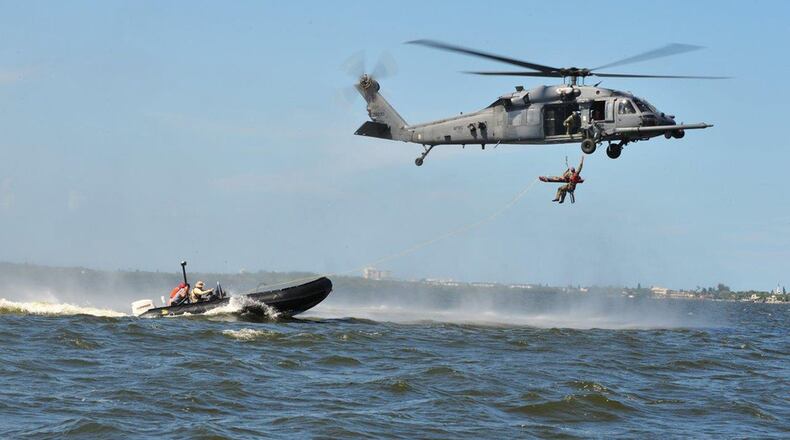A Stokes Litter carrying an accident victim is hoisted up to a UH-1N Huey helicopter from the 40th Helicopter Squadron. Once the patient is on board the aircraft, a flight surgeon or flight nurse can perform a lifesaving role while en route to a local hospital or care facility for treatment. Technology being developed by an Air Force small business partner via the Air Force Research Laboratory and AFWERX is under rapid development to prevent the litter from swinging while being hoisted and allow for safer hoists of patients. (U.S. Air Force photo/Capt. David Oettel)