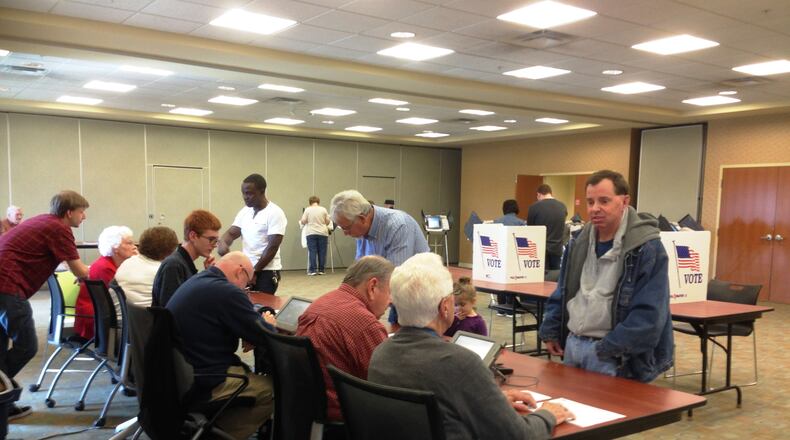 Voters and polling workers at the Butler County Board of Elections, Tuesday, Nov. 4, 2014. CHELSEY LEVINGSTON / STAFF
