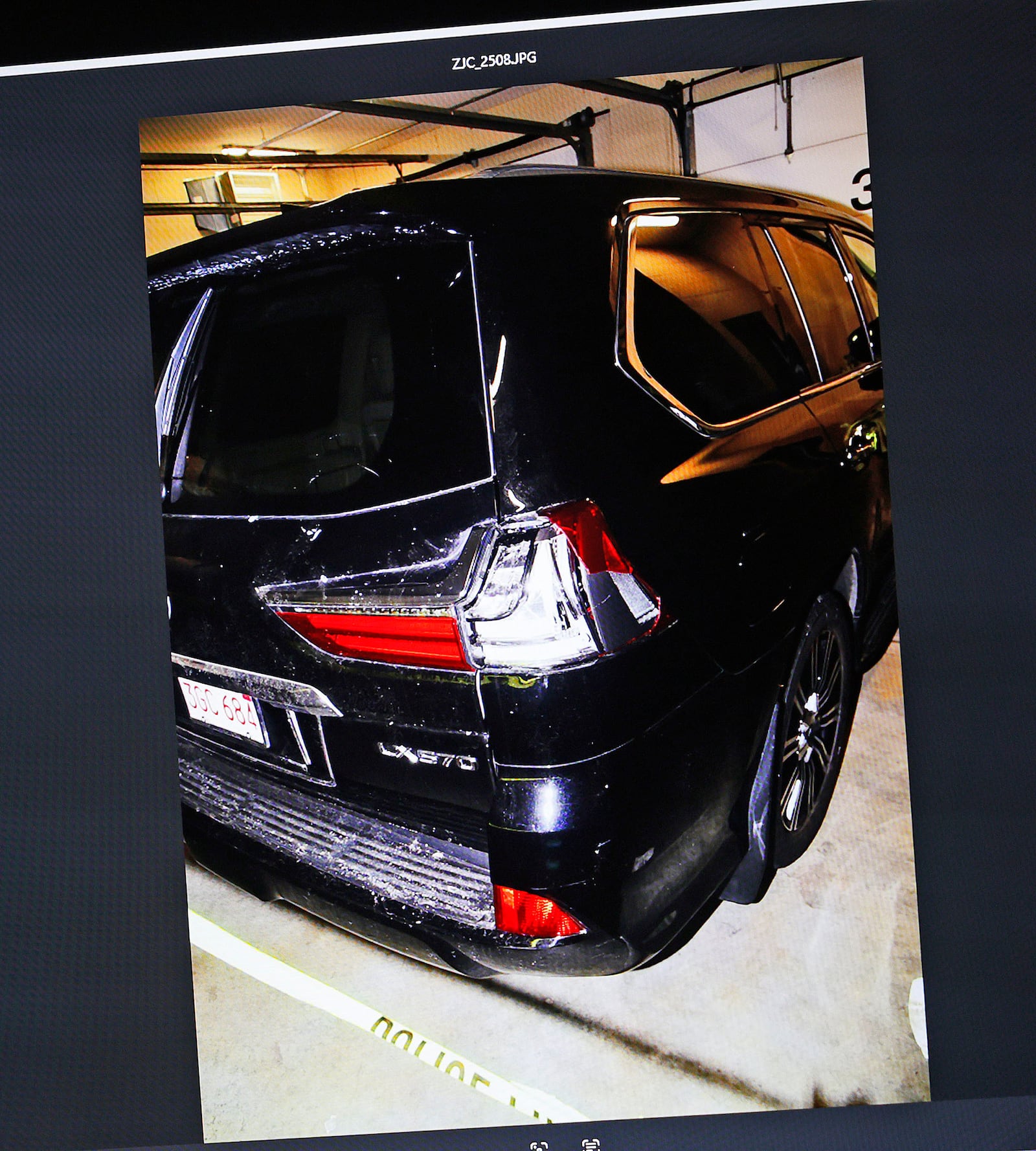 An image of Karen Read's SUV with a damaged taillight which was put into evidence is shown during the Karen Read trial in Norfolk Superior Court at Dedham, Mass., on Wednesday, April 23, 2025 (Greg Derr/The Patriot Ledger via AP, Pool)
