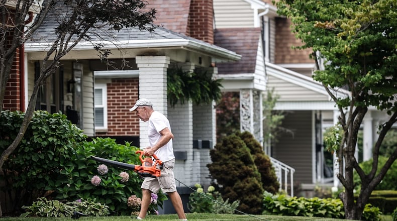 Bob Pack helps a friend with his lawn on Cushing Ave. in Kettering Thursday July 27, 2023. Most of the growth in residential value is in the southern part of county including Kettering at $987 million increase in property values. JIM NOELKER/STAFF