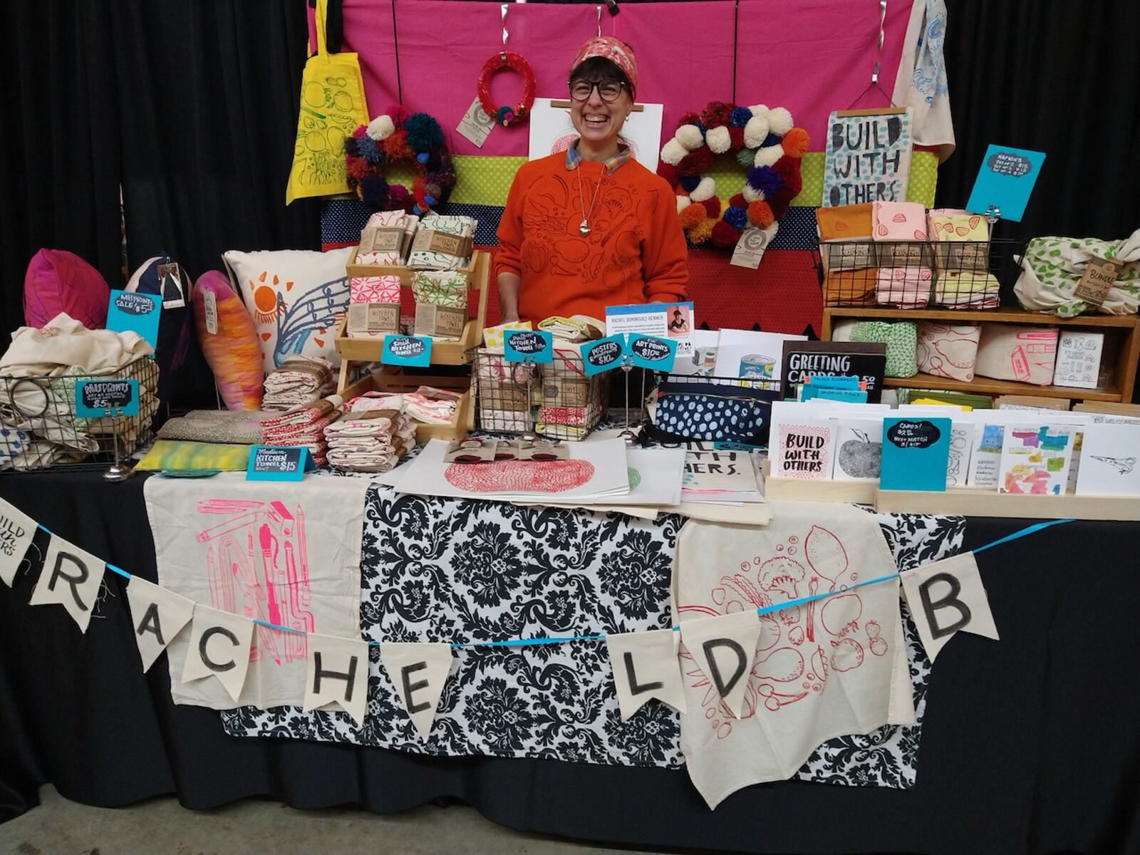 Rachel Dominguez-Benner, aka Rachel DB Creative, sells her silkscreened kitchen towels and other hand drawn products at pop-up markets around Dayton.