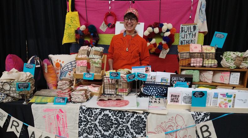 Rachel Dominguez-Benner, aka Rachel DB Creative, sells her silkscreened kitchen towels and other hand drawn products at pop-up markets around Dayton.