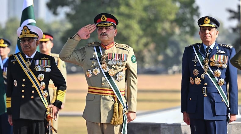 In this photo released by the Inter Services Public Relations, Pakistan's Chief of Defense Forces and Army Chief Gen. Asim Munir, center, Pakistan Naval Chief Admiral Naveed Ashraf, left, and Pakistan Air Force Chief Air Chief Marshal Zaheer Ahmed Babar attend a guard of honor ceremony at the joint military command headquarters in Rawalpindi, Pakistan, Monday, Dec. 8, 2025. (Inter Services Public Relations via AP)