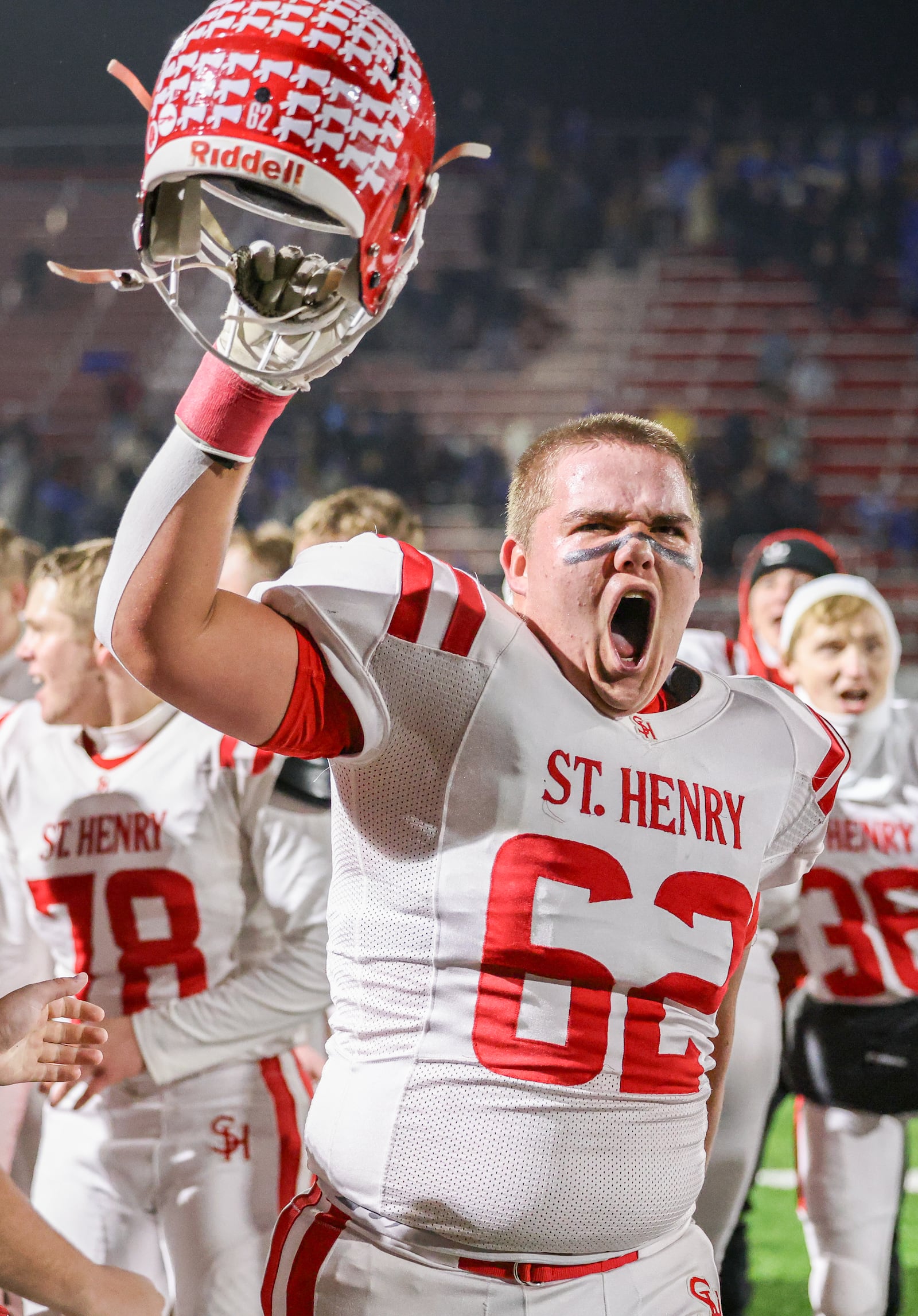 St. Henry junior lineman Jace Unrast celebrates after singing the school's fight song following a 24-7 win over Marion Local in the Division VII, Region 28 championship on Friday, Nov. 21 at Mercy Health/Wapak VFW Field. BRYANT BILLING/STAFF
