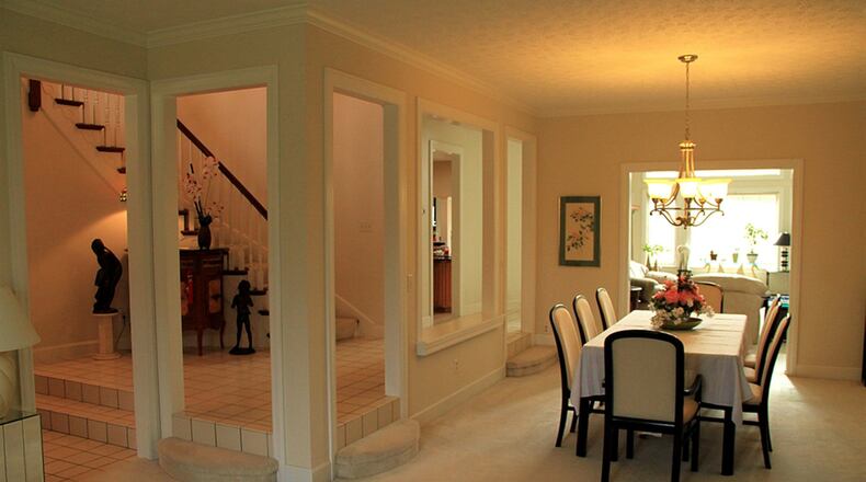 In the elongated space of the living/dining room a boxed bay window with transoms faces front.