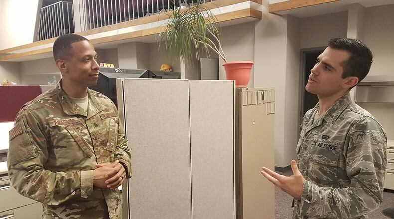 Second Lt. Evan Ewing (right), contracting specialist with the Air Force Life Cycle Management Center’s Installation Contracting Division, discusses policy with 2nd Lt. Thomas Anderson, also a contracting specialist with the division. (U.S. Air Force photo/Brian Brackens)