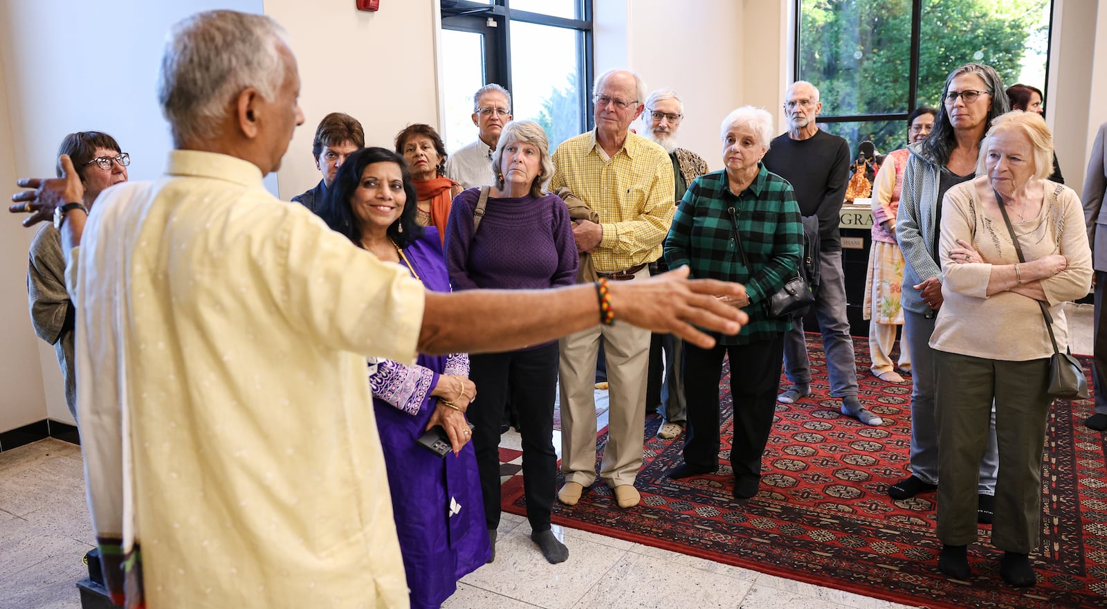 Shri Ramesh Rajaman (far left), the head priest at Hindu Temple of Dayton, speaks to an interfaith group before a service celebrating Diwali on Tuesday, Oct. 20 in Beavercreek. BRYANT BILLING/STAFF