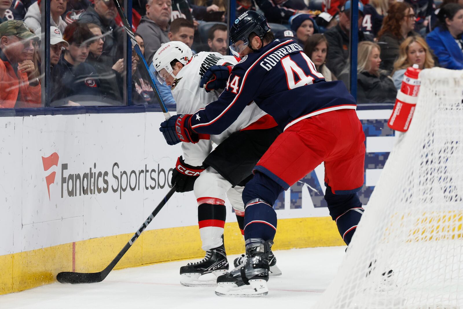 Ottawa Senators' Matthew Highmore, left, keeps the puck away from Columbus Blue Jackets' Erik Gudbranson during the first period of an NHL hockey game Tuesday, April 8, 2025, in Columbus, Ohio. (AP Photo/Jay LaPrete)