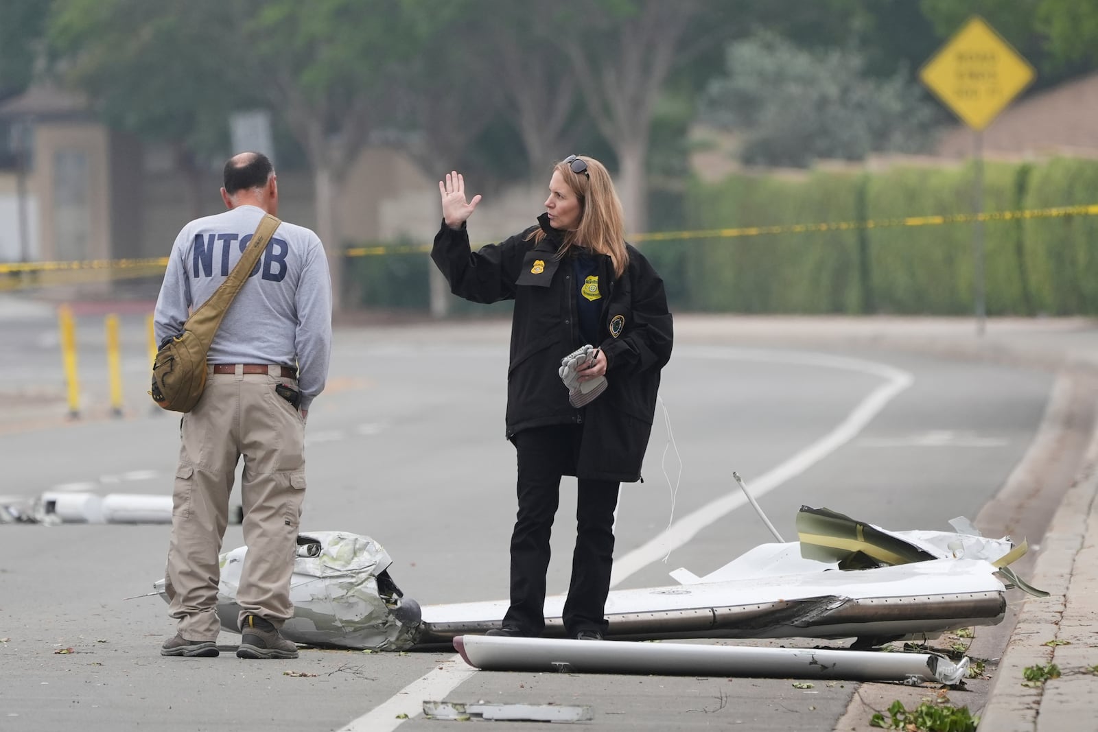 Investigators work at the site of a plane crash Friday, May 23, 2025, in San Diego. (AP Photo/Gregory Bull)