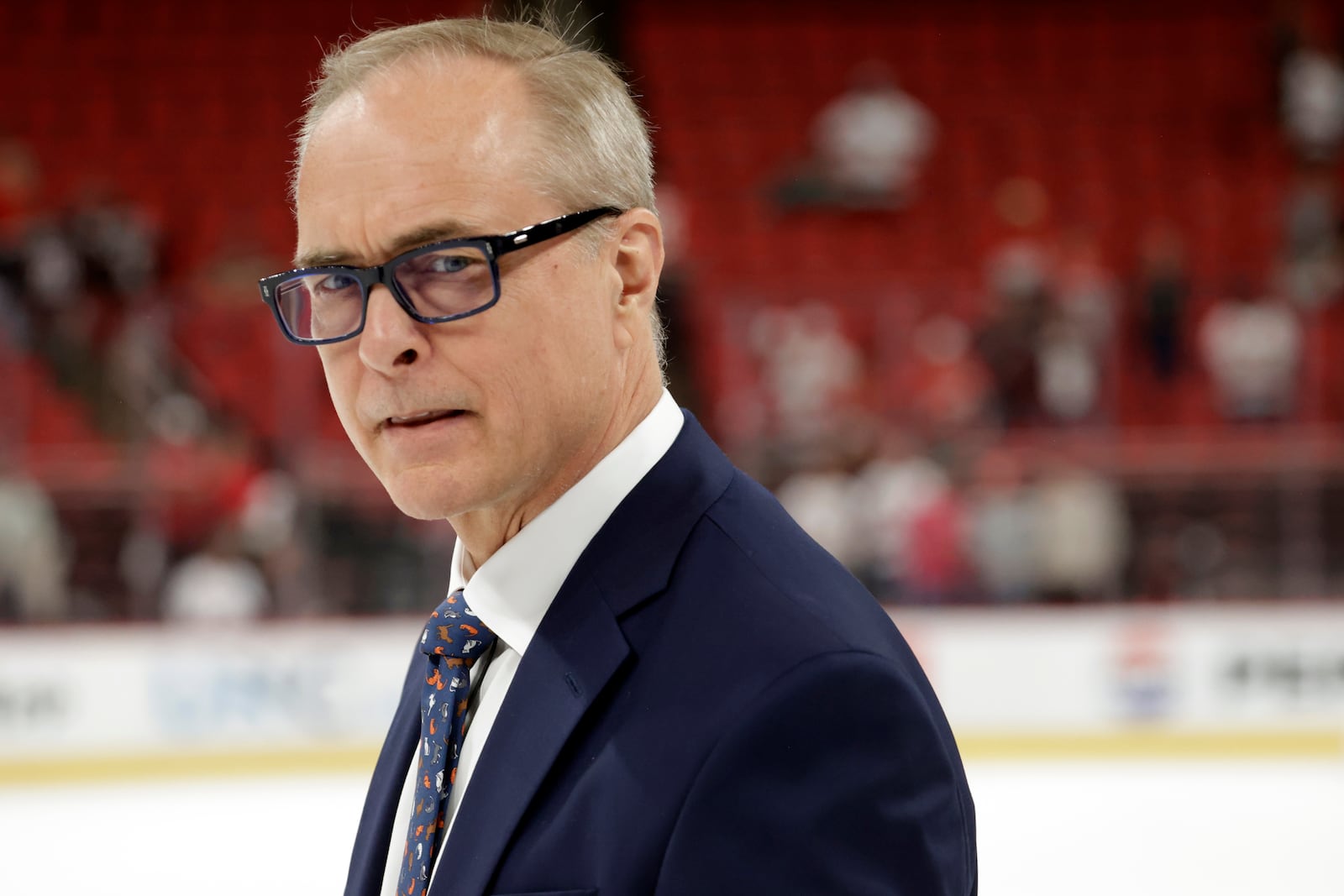 Florida Panthers head coach Paul Maurice watches as the players celebrate at the conclusion of Game 5 of the NHL hockey Stanley Cup Eastern Conference finals Wednesday, May 28, 2025, in Raleigh, N.C. The Panthers team defeated the Carolina Hurricanes to advance to the Stanley Cup finals. (AP Photo/Chris Seward)
