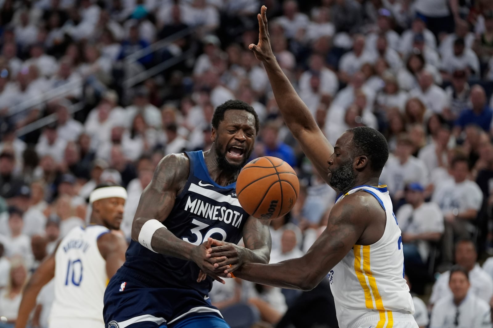Minnesota Timberwolves forward Julius Randle (30) is fouled by Golden State Warriors forward Draymond Green (23) during the second half of Game 5 of an NBA basketball second-round playoff series, Wednesday, May 14, 2025, in Minneapolis. (AP Photo/Abbie Parr)